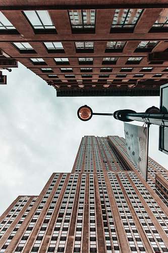 building low angle photography of light post between two high-rise buildings high rise
