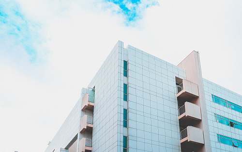 building low angle photography of white and brown concrete building during daytime urban