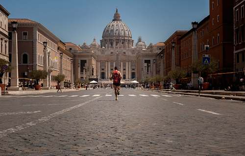 human man running near concrete building person