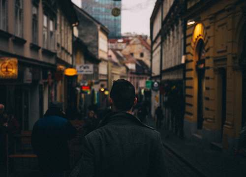 street man standing between hallway town