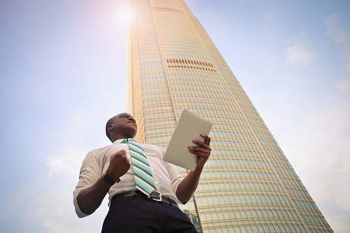 town man standing near high-rise building urban