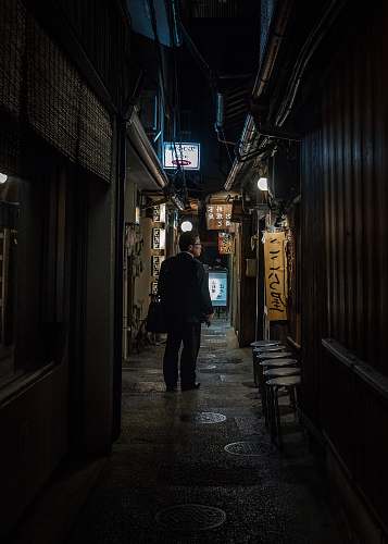 building man standing on focus photography road