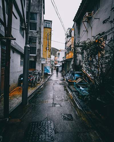 building man walking on pathway under white sky road