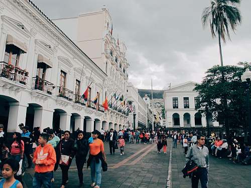 urban people walking beside building at daytime town