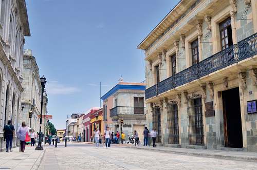 town people walking on street under clear blue sky urban