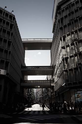 building people walking under pass road