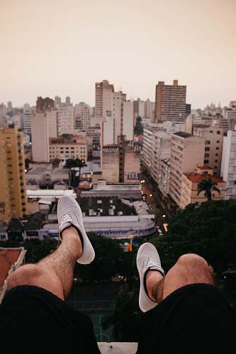 apparel person pair of wearing gray sneakers clothing
