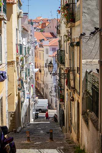 building person standing in building alley road