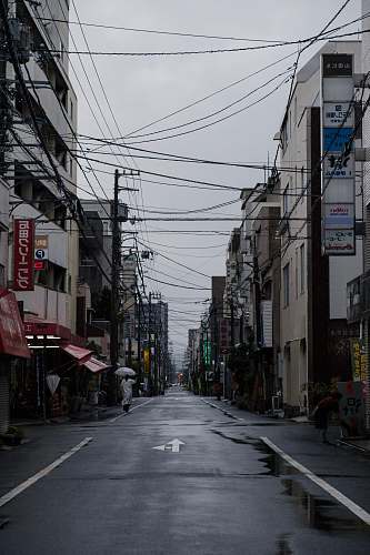 building person wearing white shirt under white umbrella urban