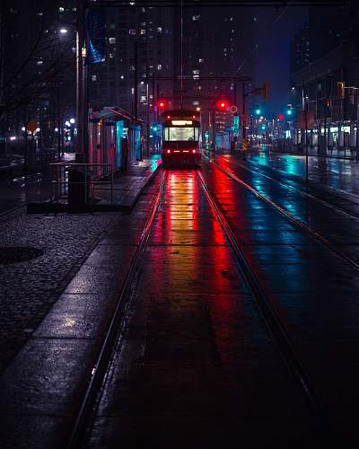 urban photo of tram beside waiting station during nighttime night