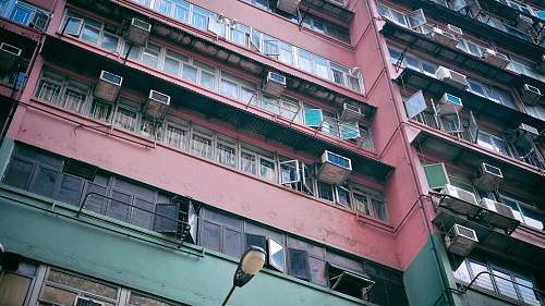 building pink and green painted building high rise