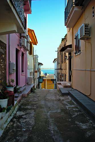 building road between buildings during day road