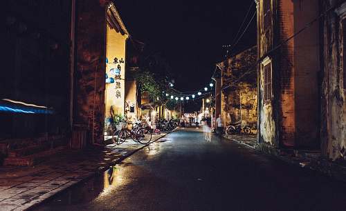 town street beside village with lights during night time lights