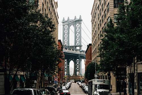 dumbo street with car lot in the middle of high-rise buildings building