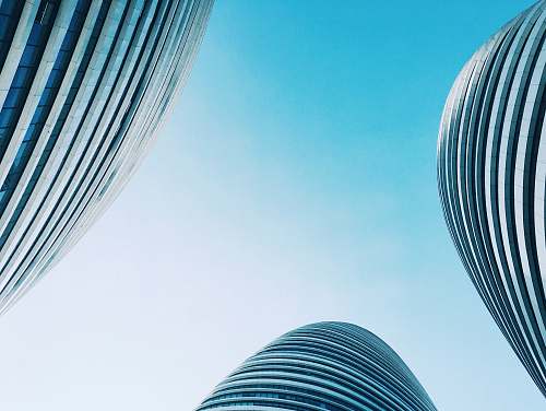 building three low angle photography of buildings town