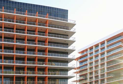 building two brown concrete buildings high rise