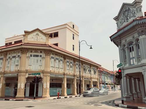 building two vehicles beside buildings road