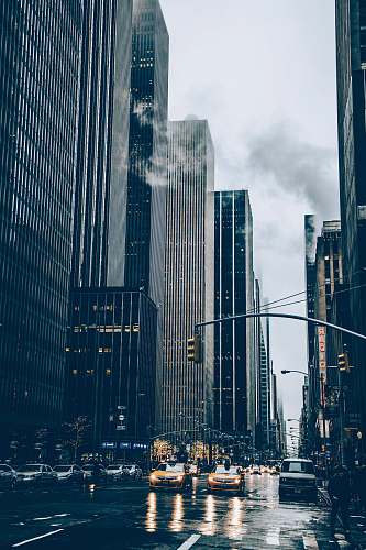 urban two yellow cars besides concrete buildings new york