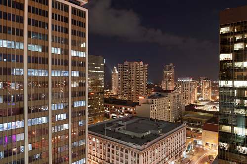 town urban photo of brown buildings at night urban