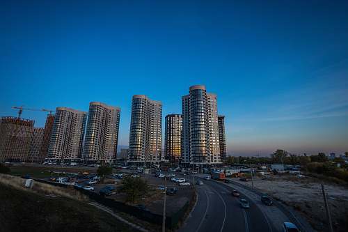 building vehicles crossing road near buildings high rise