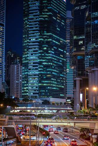 building vehicles on road near high buildings at nighttime town