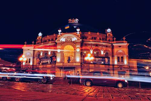 building vehicles travelling on road during nighttime time lapse photography town