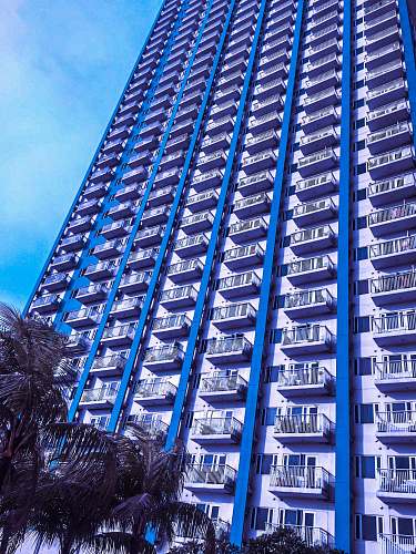 building view of white and blue painted apartment complex high rise