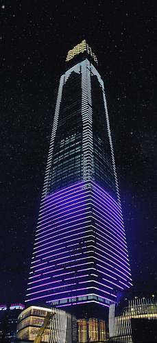building white and violet lit building high rise