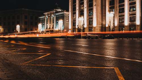 downtown white concrete building lights turned on during nighttime urban