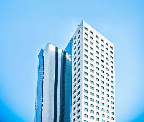 building white concrete building under blue sky high rise