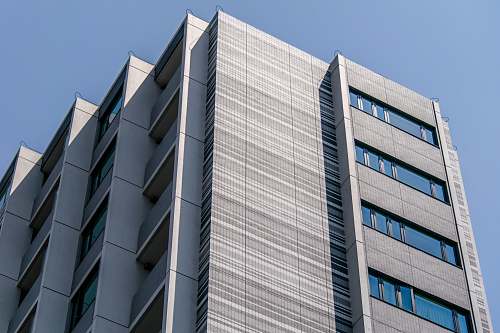 building white concrete high-rise building under blue sky home decor