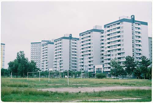 building white painted building under clear blue sky high rise