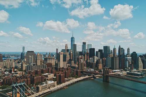 building wide angle photo of Brooklyn Bridge under cloudy sky skyline