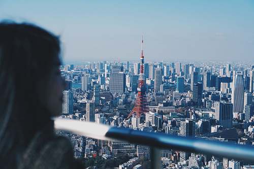building woman watching city building high rise