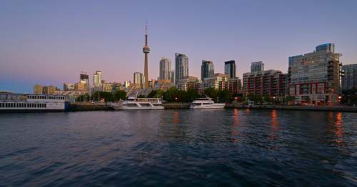 building yacht docked near high rise buildings urban