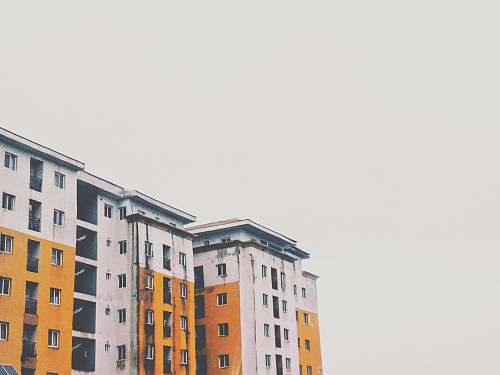 urban yellow and white concrete high-rise building town