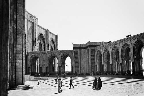 black-and-white grayscale photography of people walking near building town