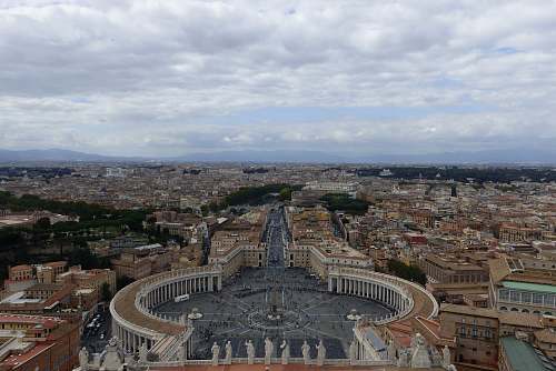 nature aerial photography of a city under a cloudy sky outdoors