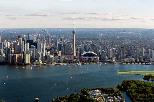 outdoors gray buildings near body of water in aerial photo landscape