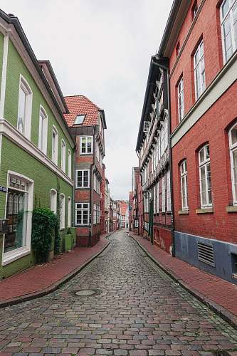 walkway road between red and green houses city