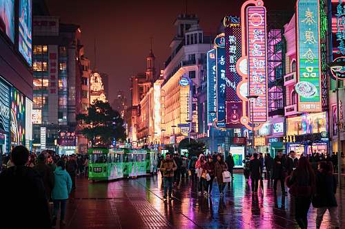 person people walking and standing at the streets of the city during night human