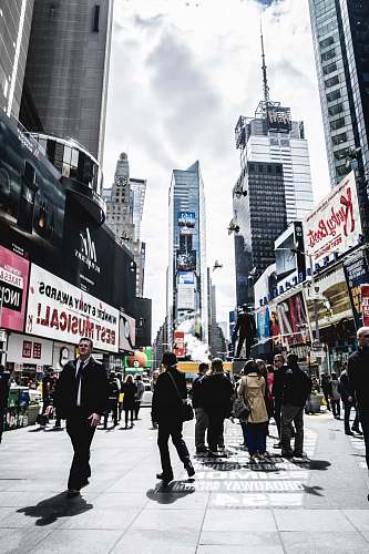 human people walking in street beside buildings person