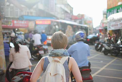 people woman wearing backpack walking on road traffic