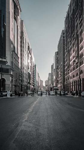 black-and-white people crossing road during daytime town