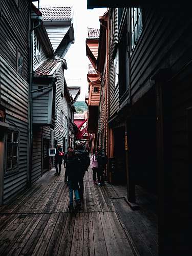 street people walking on narrow pathway during daytime town