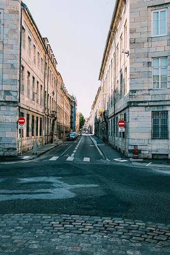 asphalt two beige concrete buildings tarmac