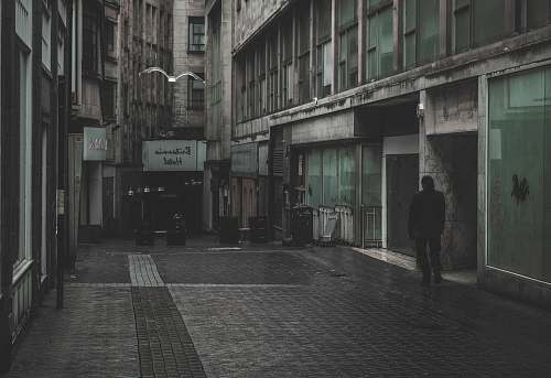 path man standing between building walkway