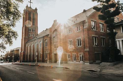 city brown church under cloudy sky building