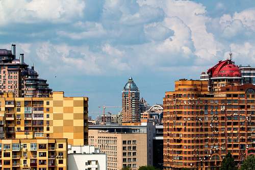 city building under cloudy sky at daytime town