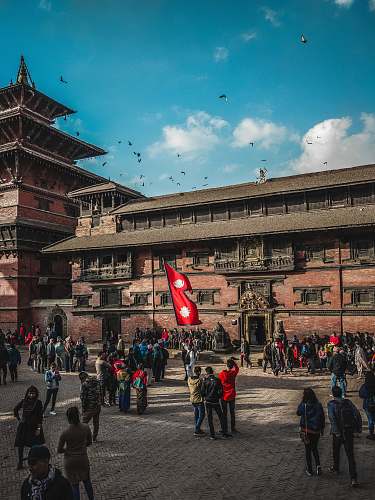 town people standing near building during daytime city